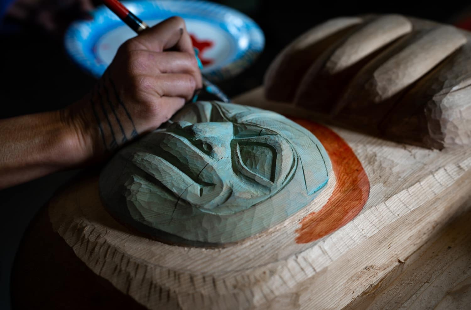 Closeup of final painting touches on the Kaagwaantaaan pole for the Kootéeyaa Deiyí (Totem Pole Trail), in Juneau.