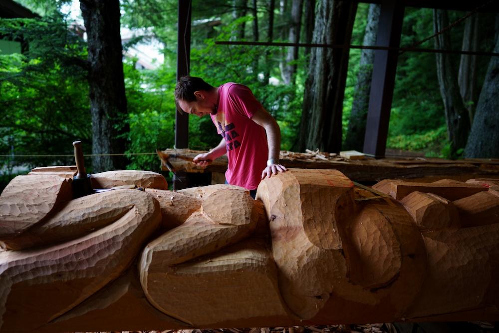 Will Peterson helps carve the Eagle Pole for the Kootéeyaa Deiyí (Totem Pole Trail) in Juneau.