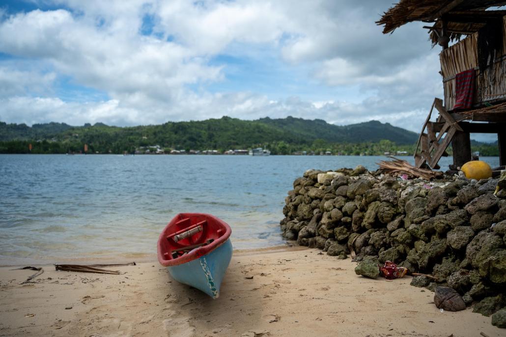 Photo of blue canoe on the beach.